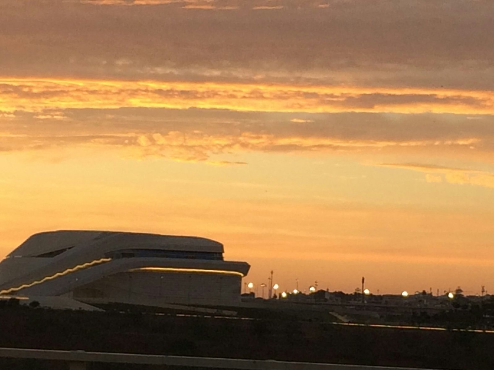 a plane is flying in the sky at sunset